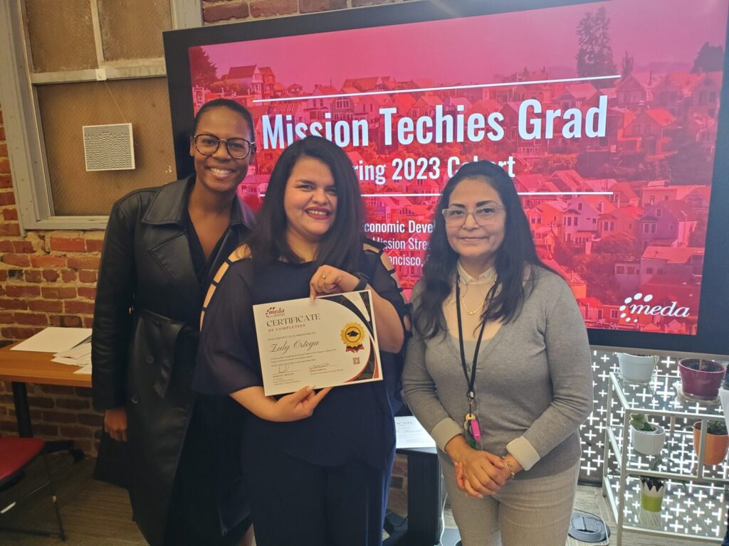 Woman holding a certificate, next to instructors.