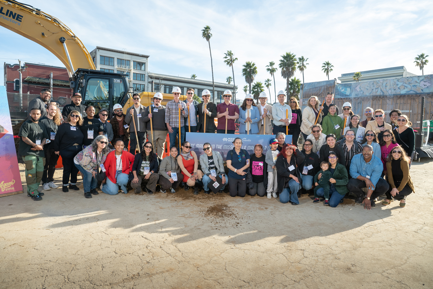 Large group of people at construction site event.